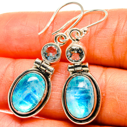 Sterling silver drop earrings with oval turquoise-blue stones and small round blue gems