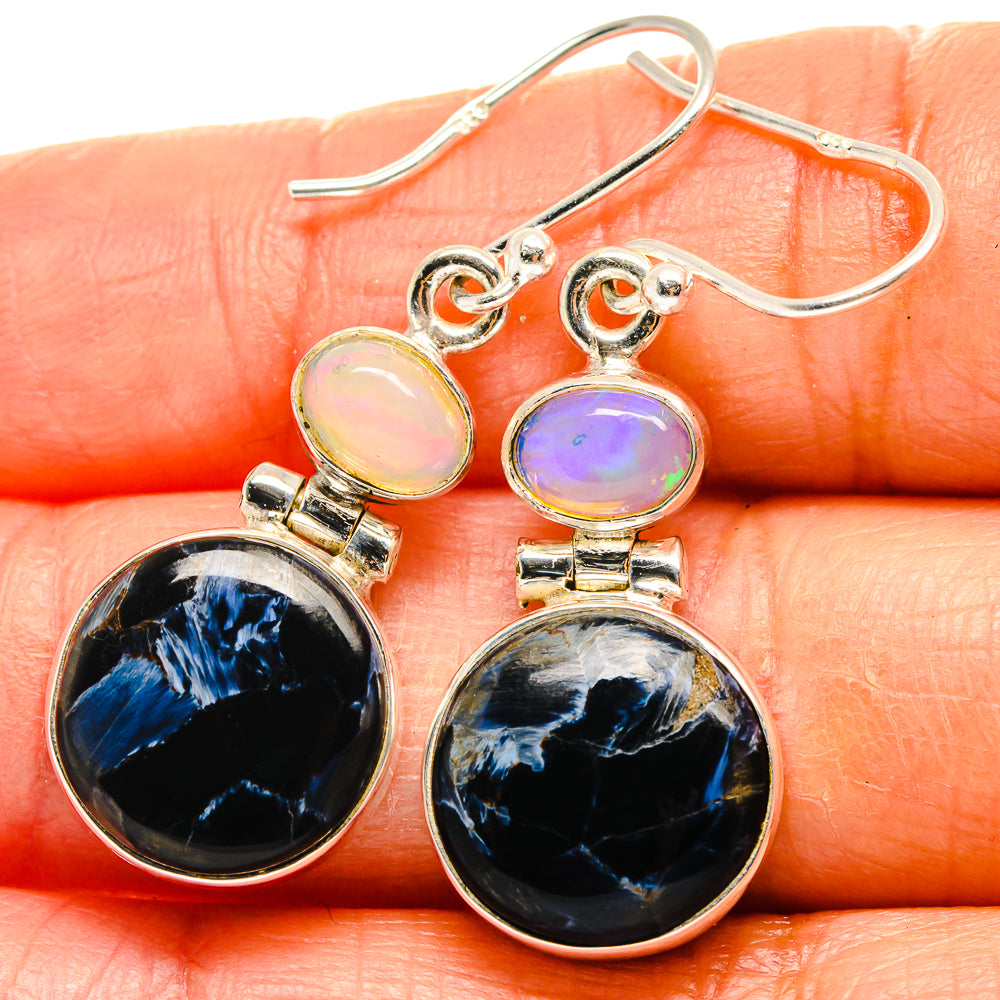 Sterling silver drop earrings with dark blue pietersite and pale opal accents
