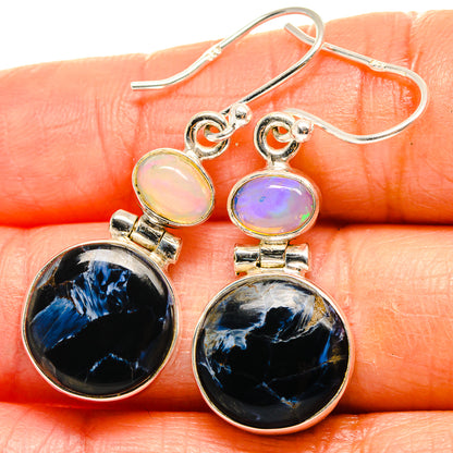 Sterling silver drop earrings with dark blue pietersite and pale opal accents