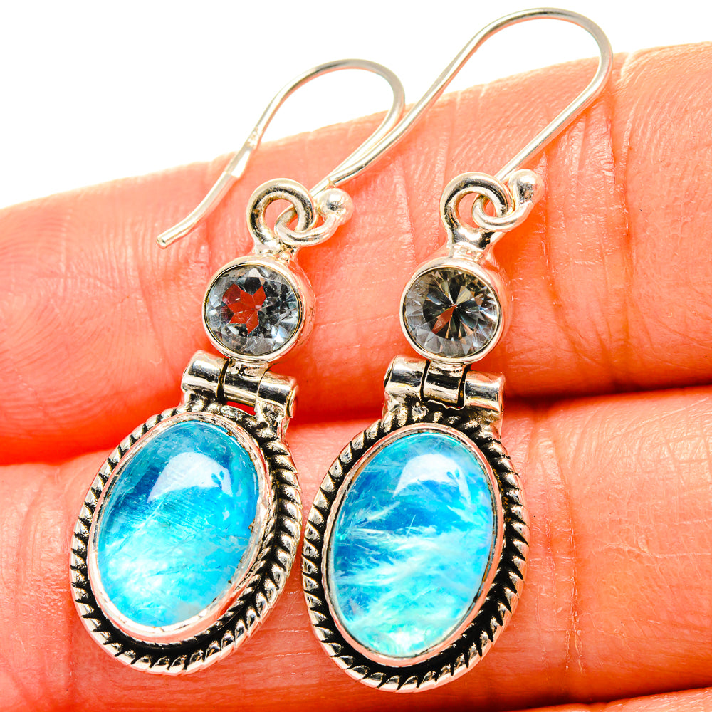 Sterling silver drop earrings with oval blue cabochon and round red center charm