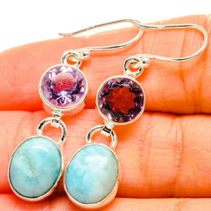 Close-up sterling silver earrings: round purple amethyst top and oval aqua larimar drop