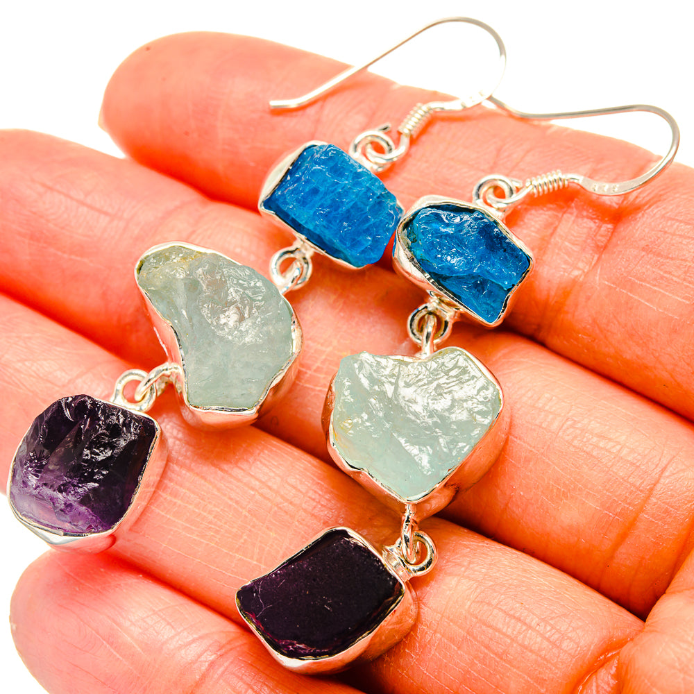 Rough stone dangle earrings in blue, green, and amethyst with silver hooks