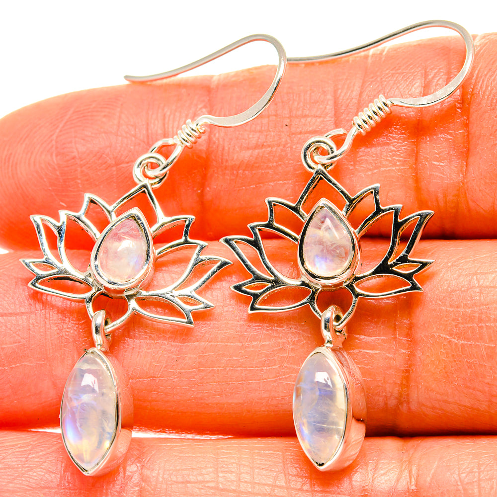 Silver lotus drop earrings with iridescent moonstone teardrop stones on fishhook.