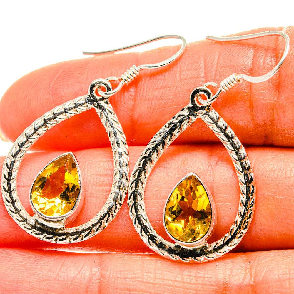 Sterling silver teardrop earrings with faceted yellow citrine stone, ornate rope frame