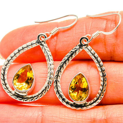 Sterling silver teardrop earrings with faceted yellow citrine stone, ornate rope frame