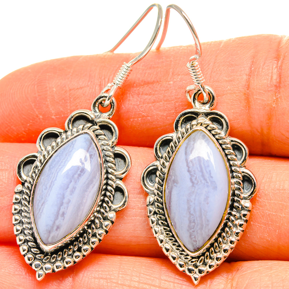Blue lace agate earrings in sterling silver with oval drop stones and decorative scalloped halos