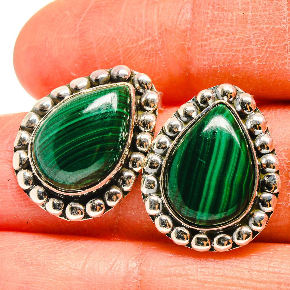 Close-up teardrop malachite earrings with green gemstone and silver beaded frame