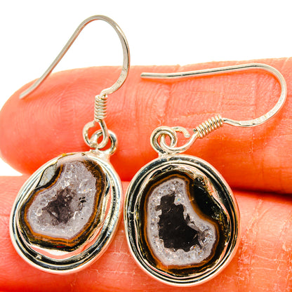 Druzy geode earrings close-up: sterling-silver hooks with oval black and brown druzy stones