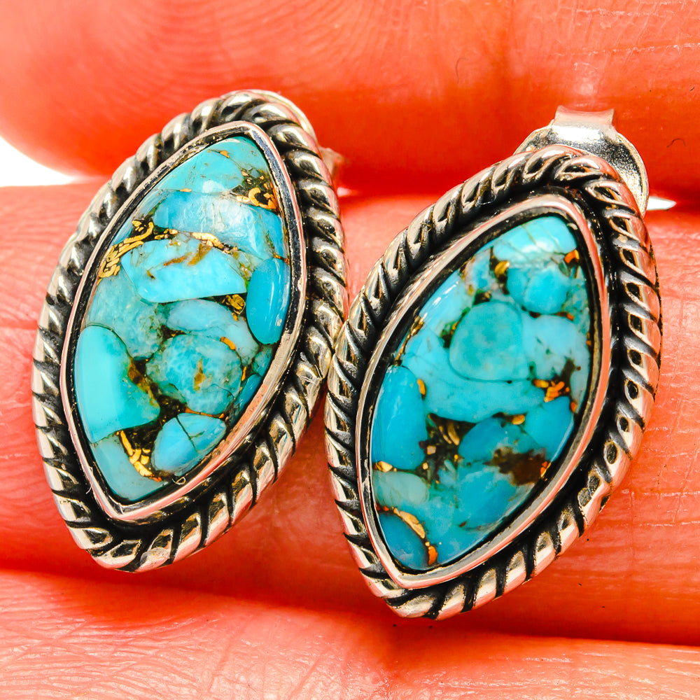 Turquoise oval cabochon stud earrings in ornate silver-tone setting
