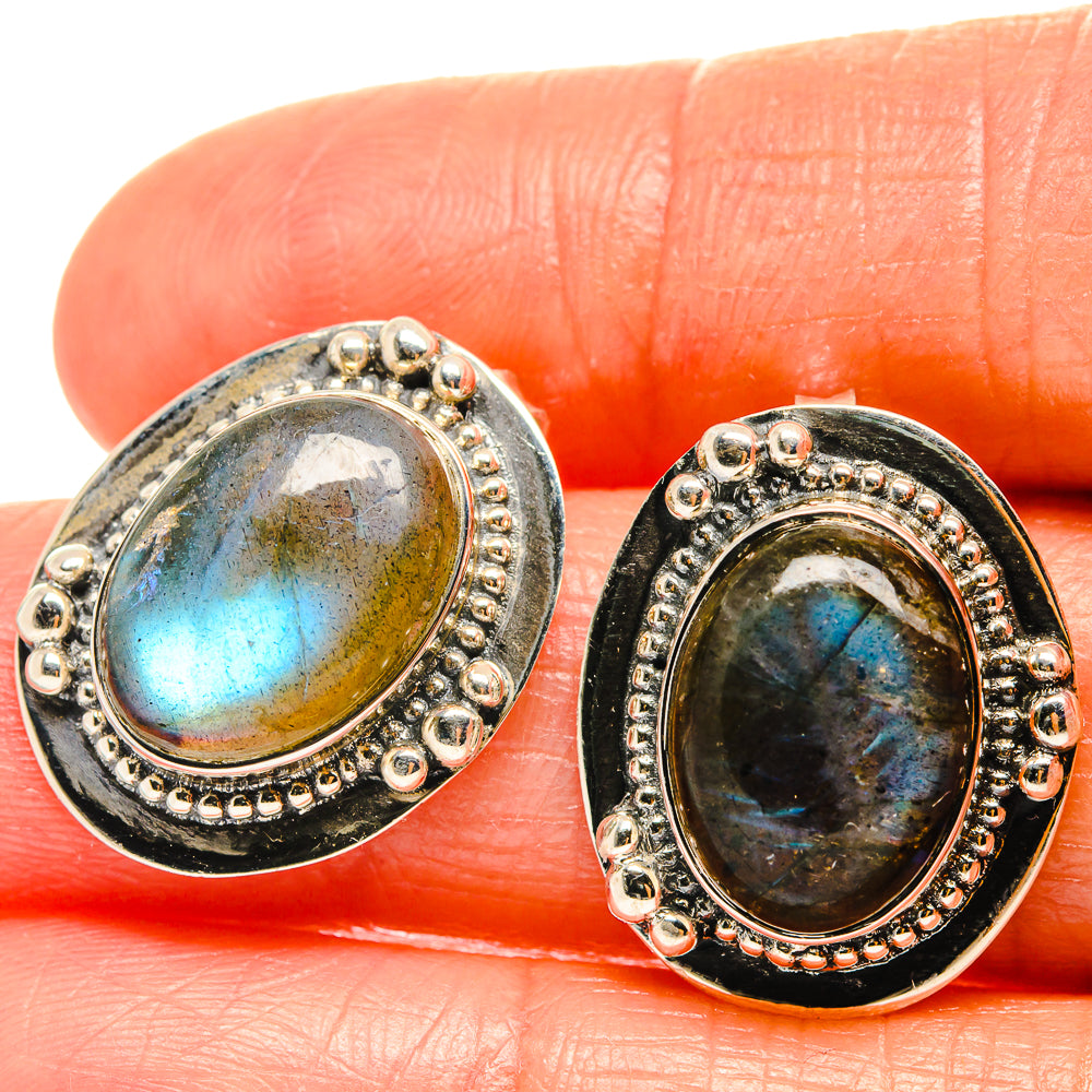Oval labradorite stud earrings in silver-tone bezel with beaded border, dark blue flash