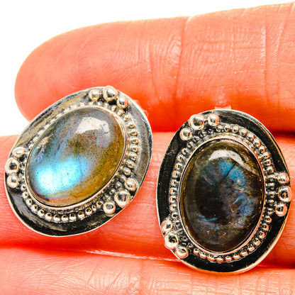 Oval labradorite stud earrings in silver-tone bezel with beaded border, dark blue flash