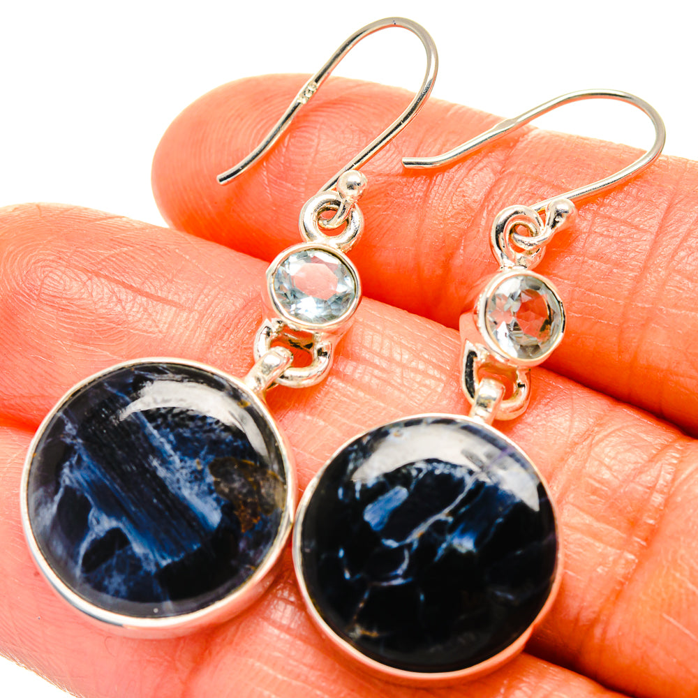 Sterling silver drop earrings with dark blue pietersite discs and light blue topaz dangles