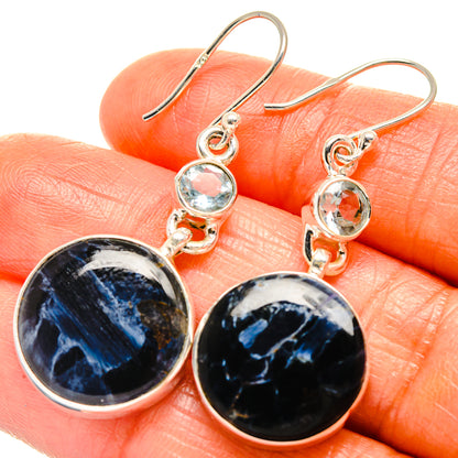 Sterling silver drop earrings with dark blue pietersite discs and light blue topaz dangles