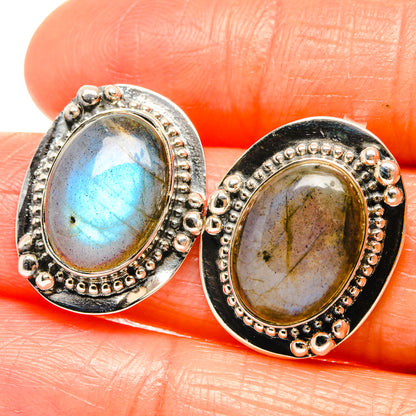 Oval labradorite stud earrings in 925 sterling silver, blue-green stones in beaded bezel.
