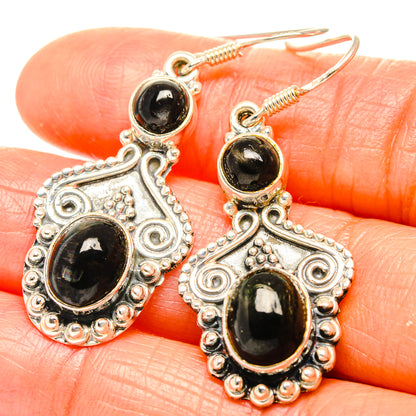 Sterling silver drop earrings with dark star diopside cabochons and ornate filigree