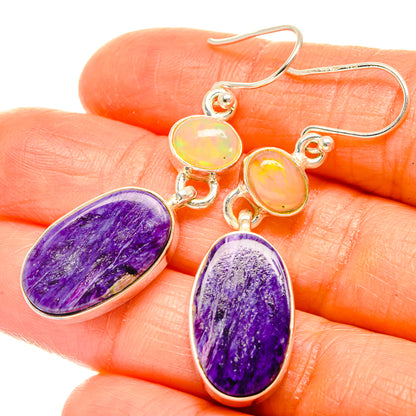 Oval purple dangle earrings with small opal-like yellow stones, silver French hooks