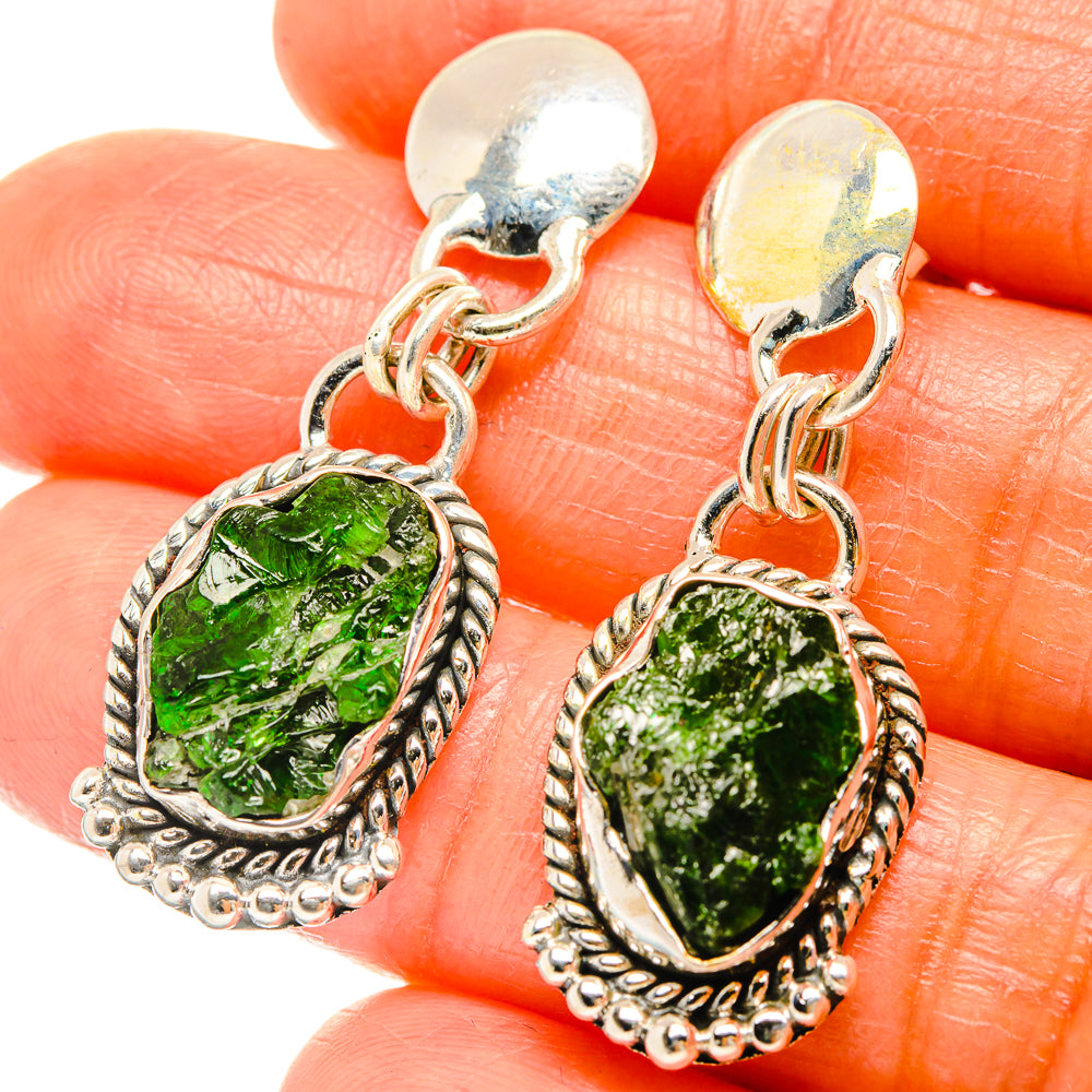 Close-up of green rough chrome diopside drop earrings with rope-edge 925 sterling frames