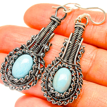 Sterling silver teardrop earrings with blue oval larimar and spiral wire details
