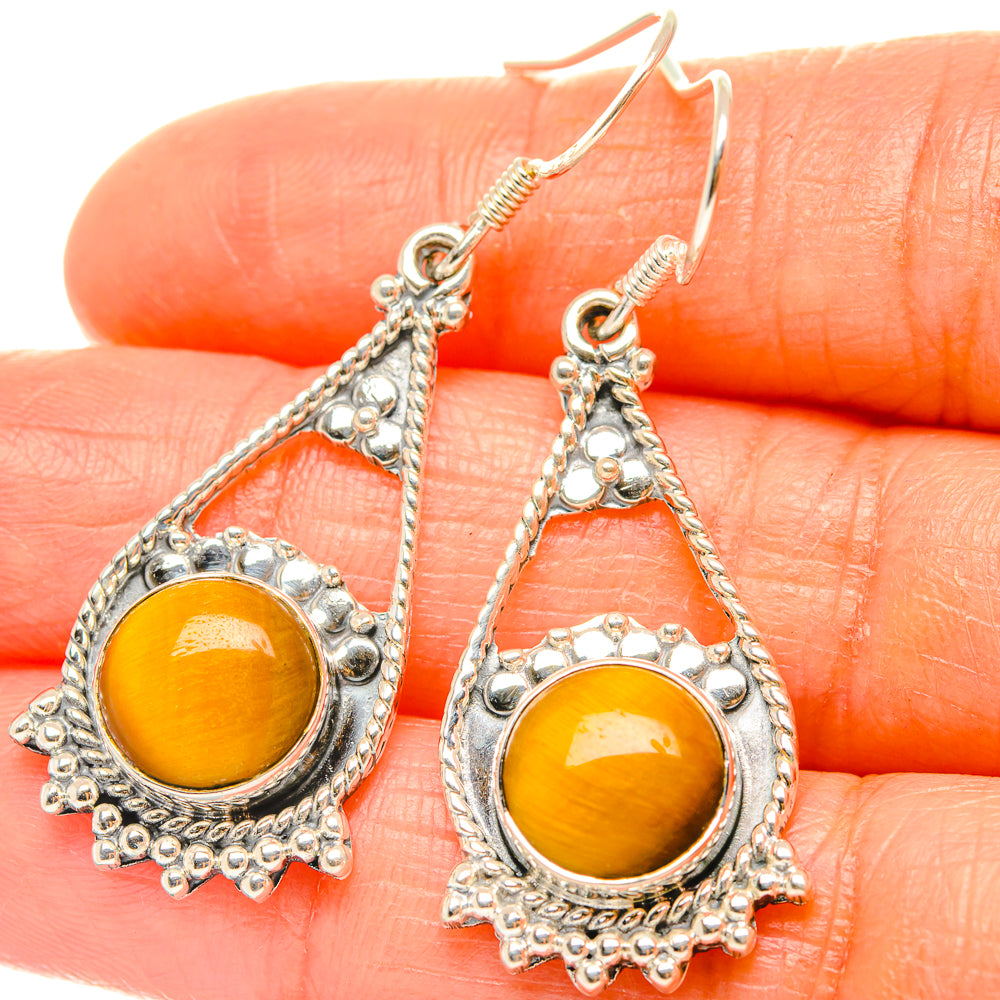 Orange tiger-eye cabochon in silver teardrop drop earring with textured border