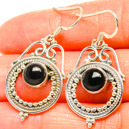 Sterling silver drop earrings with round black onyx and ornate beadwork frame