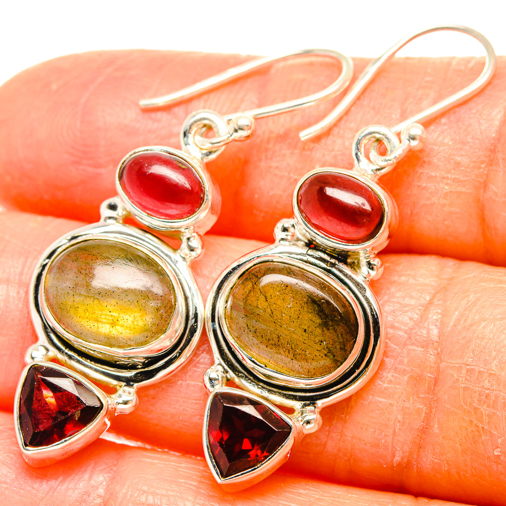 Sterling silver drop earrings with red oval gemstones, yellow round stones, and red triangle accents