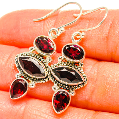 Sterling silver drop earrings with oval and teardrop red garnet-style stones, ornate setting