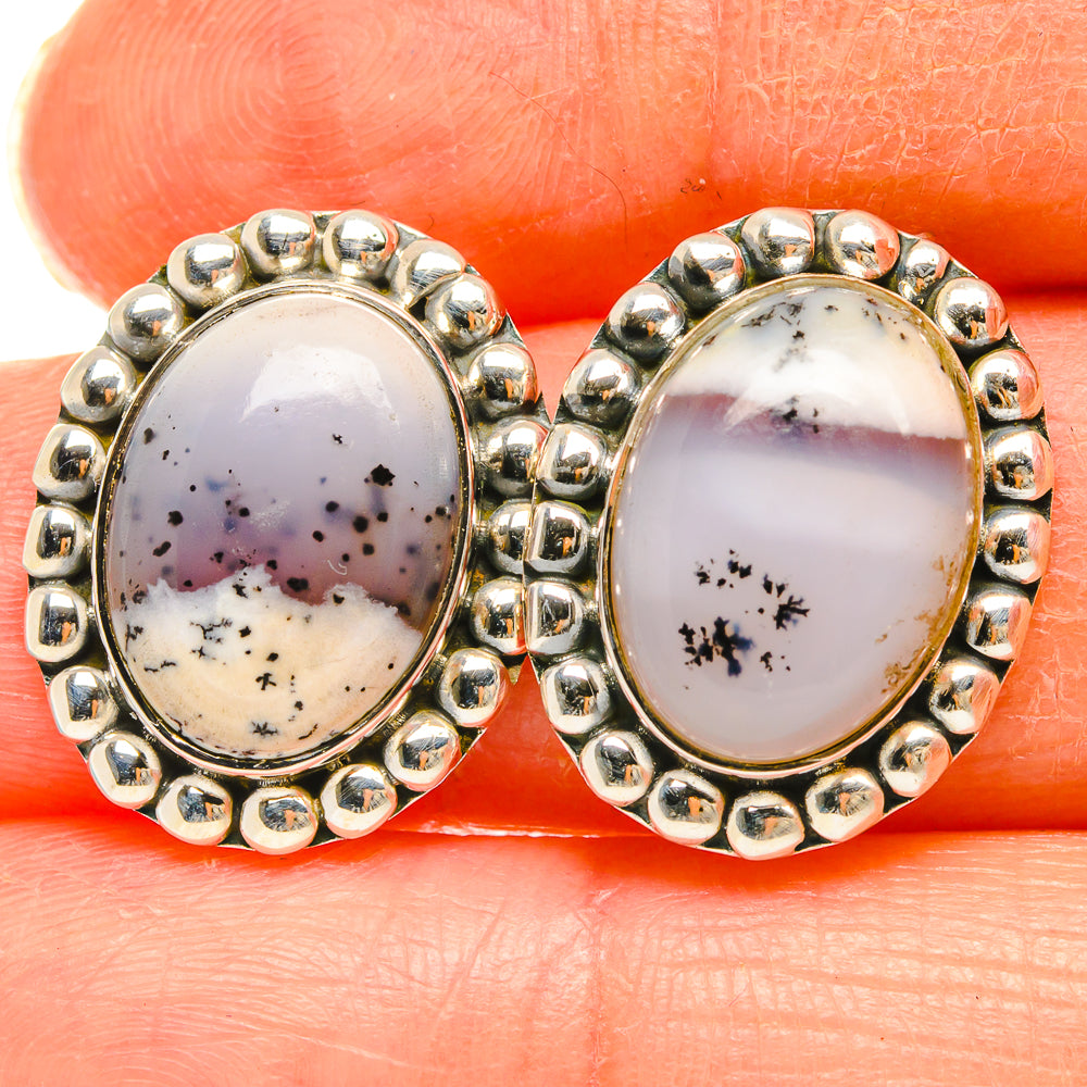 Close-up of oval dendritic opal stud earrings, sterling silver beaded bezel