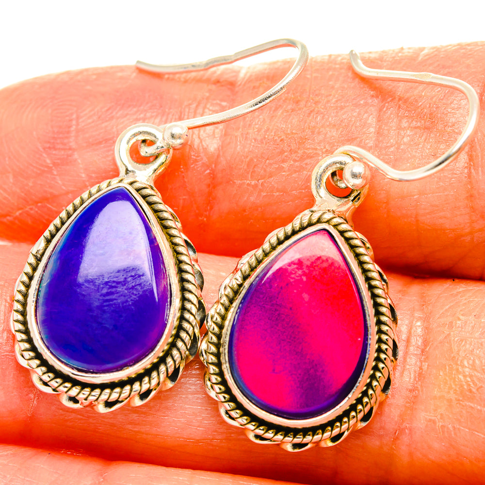 Sterling silver opal teardrop earrings, one blue and one pink teardrop in gold-tone settings