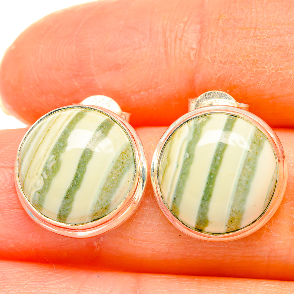 Close-up of sterling silver stud earrings with oval ocean jasper cabochons, green stripes