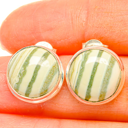 Close-up of sterling silver stud earrings with oval ocean jasper cabochons, green stripes