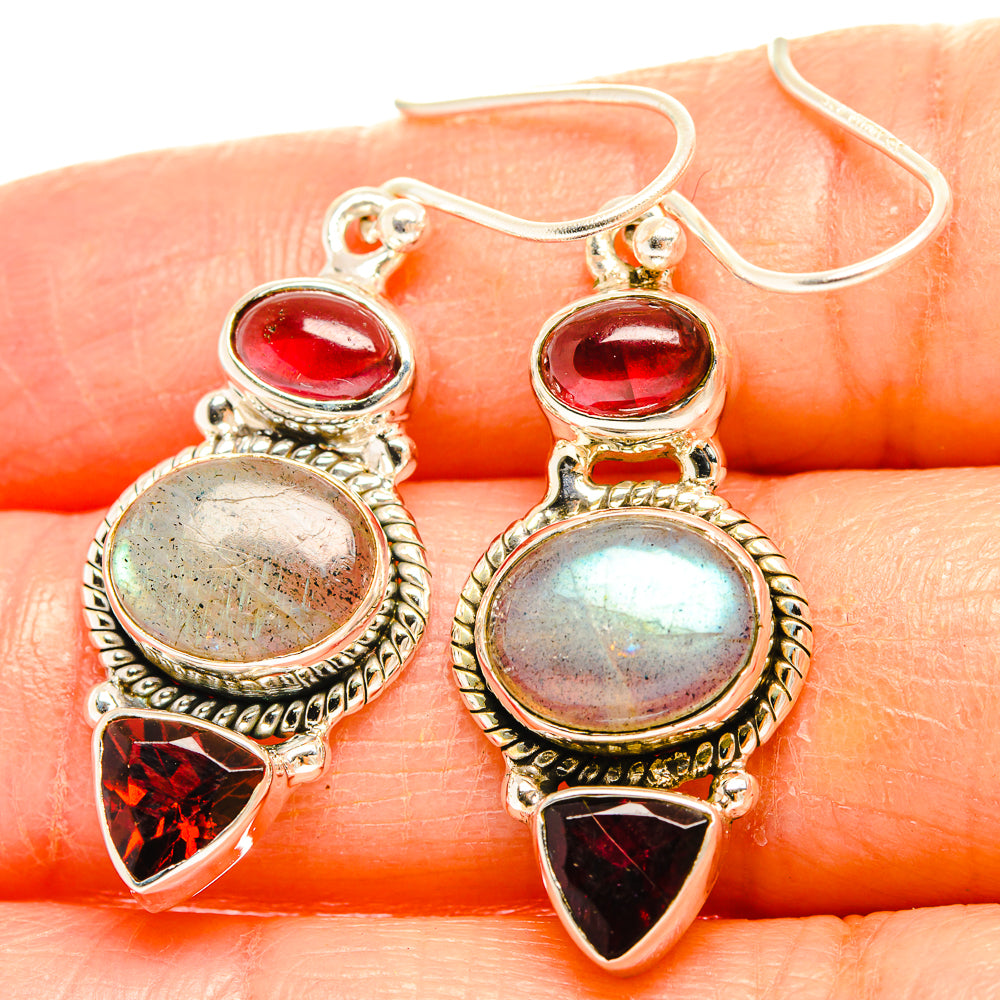 Sterling silver earrings with red stones, iridescent round cabochon, and red teardrop accents
