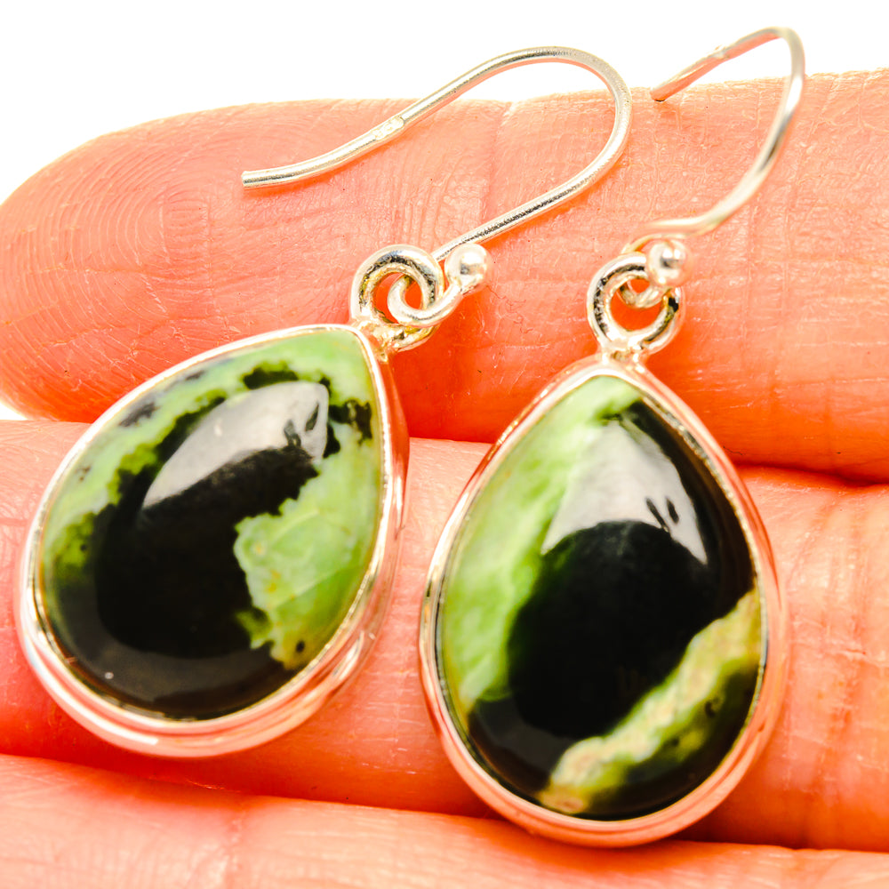 Close-up of 925 sterling silver teardrop rainforest opal drop earrings with fishhook
