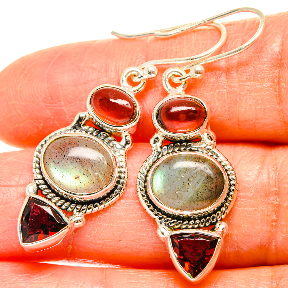 Sterling silver dangling earrings with oval amber and red triangle garnet accents