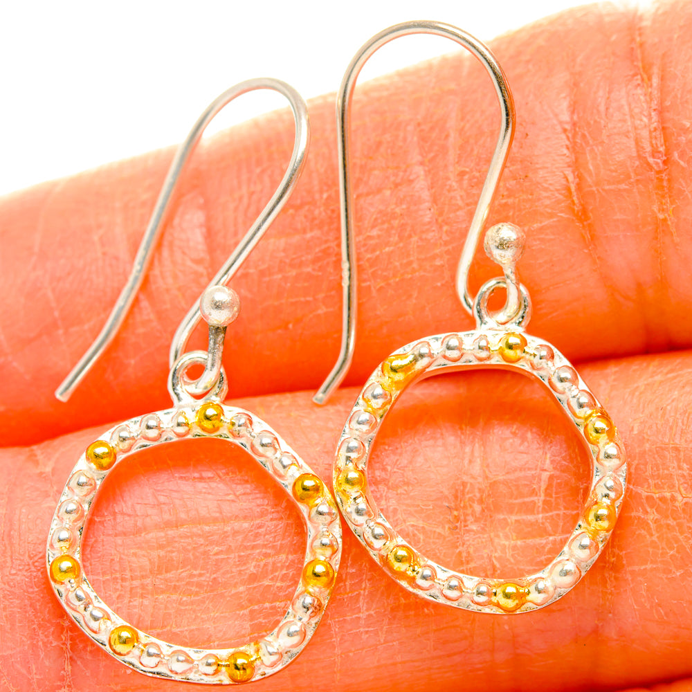 Sterling silver hoop earrings with round open circle and gold bead accents, dangle style