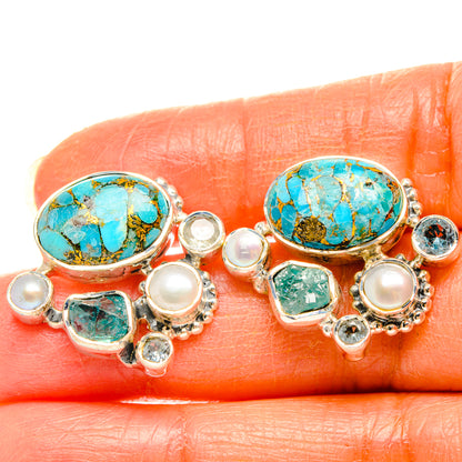 Close-up turquoise oval pearl earrings with silver-tone bezel and blue-green square stones