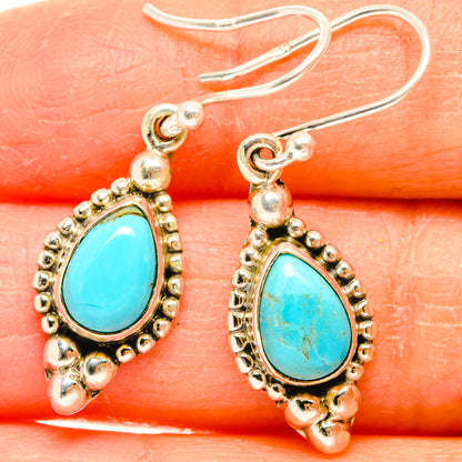 Larimar teardrop hook earrings with turquoise-blue stones and ornate beaded silver settings