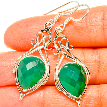 Sterling silver drop earrings with green onyx-style oval stones and filigree hooks