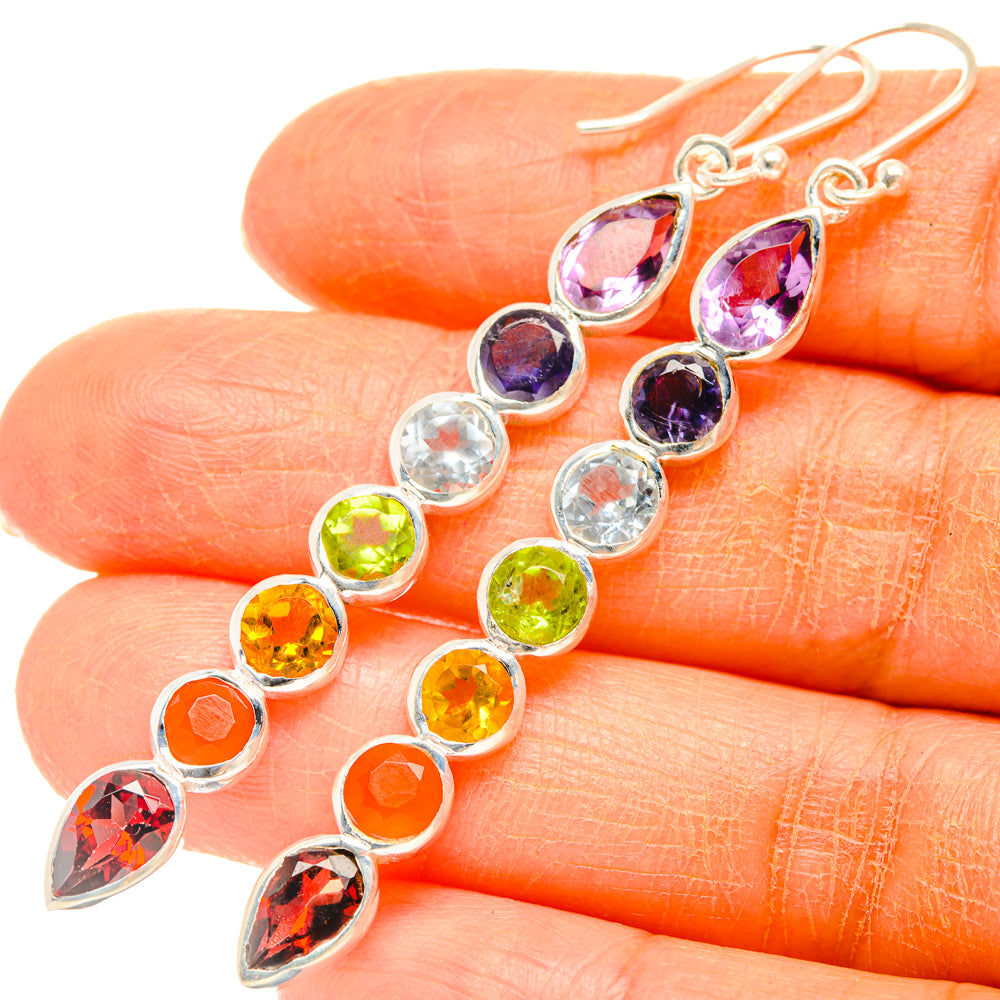 Rainbow chakra drop earrings closeup: silver hooks with rainbow faceted stones