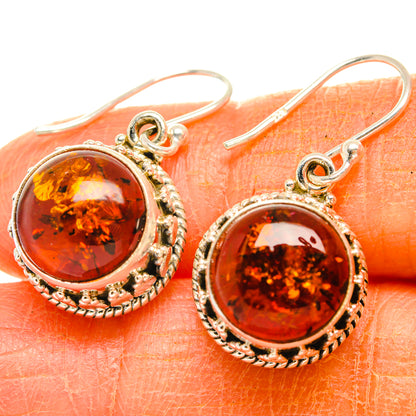 Close-up amber drop earrings with round cabochon in 925 sterling silver