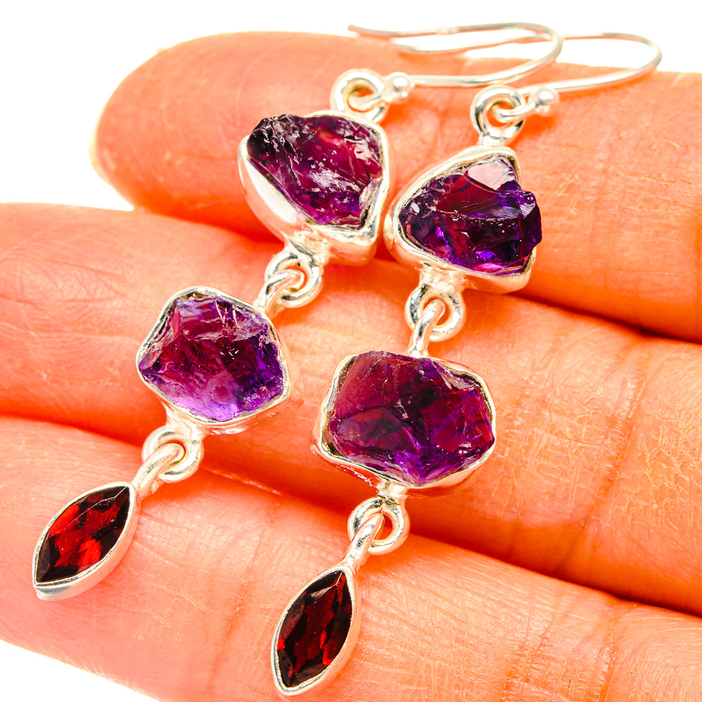 Sterling silver amethyst & garnet earrings closeup: faceted red drop charms, rough purple beads