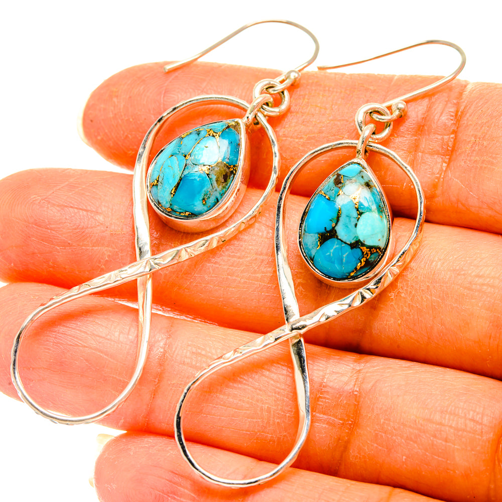 Turquoise oval drop earrings in silver with ornate loops and long hook wires