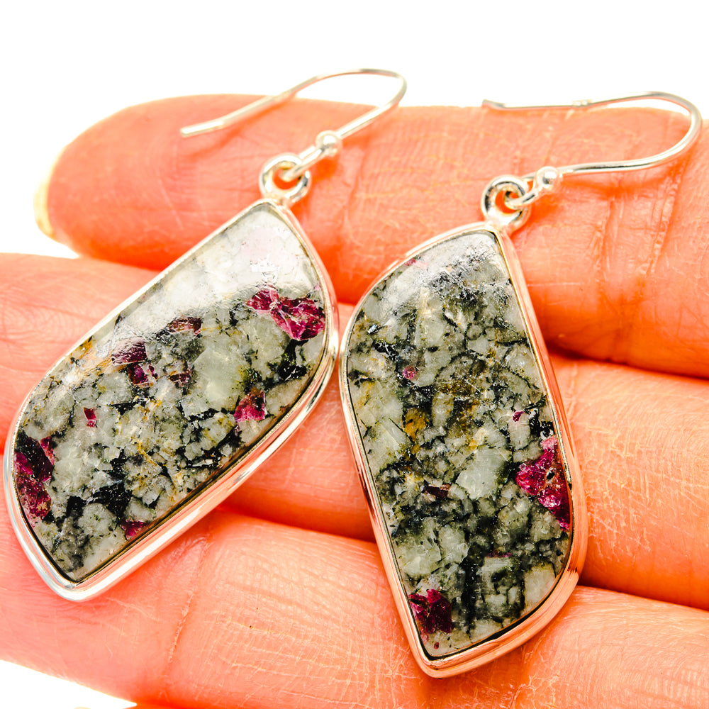 Close-up teardrop earrings with speckled green and pink Russian eudialyte in silver