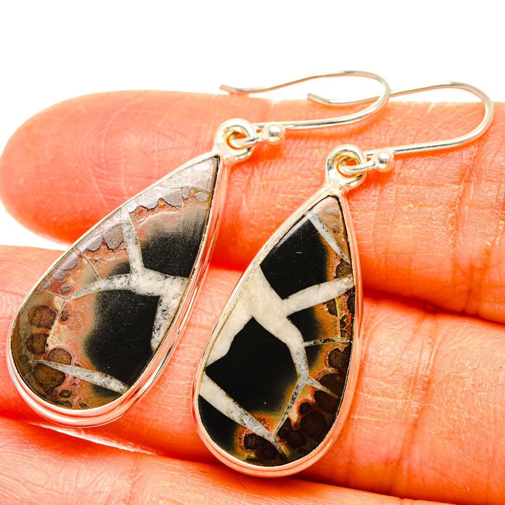 Teardrop septarian geode earrings with black, orange, and white mosaic stone and silver hook