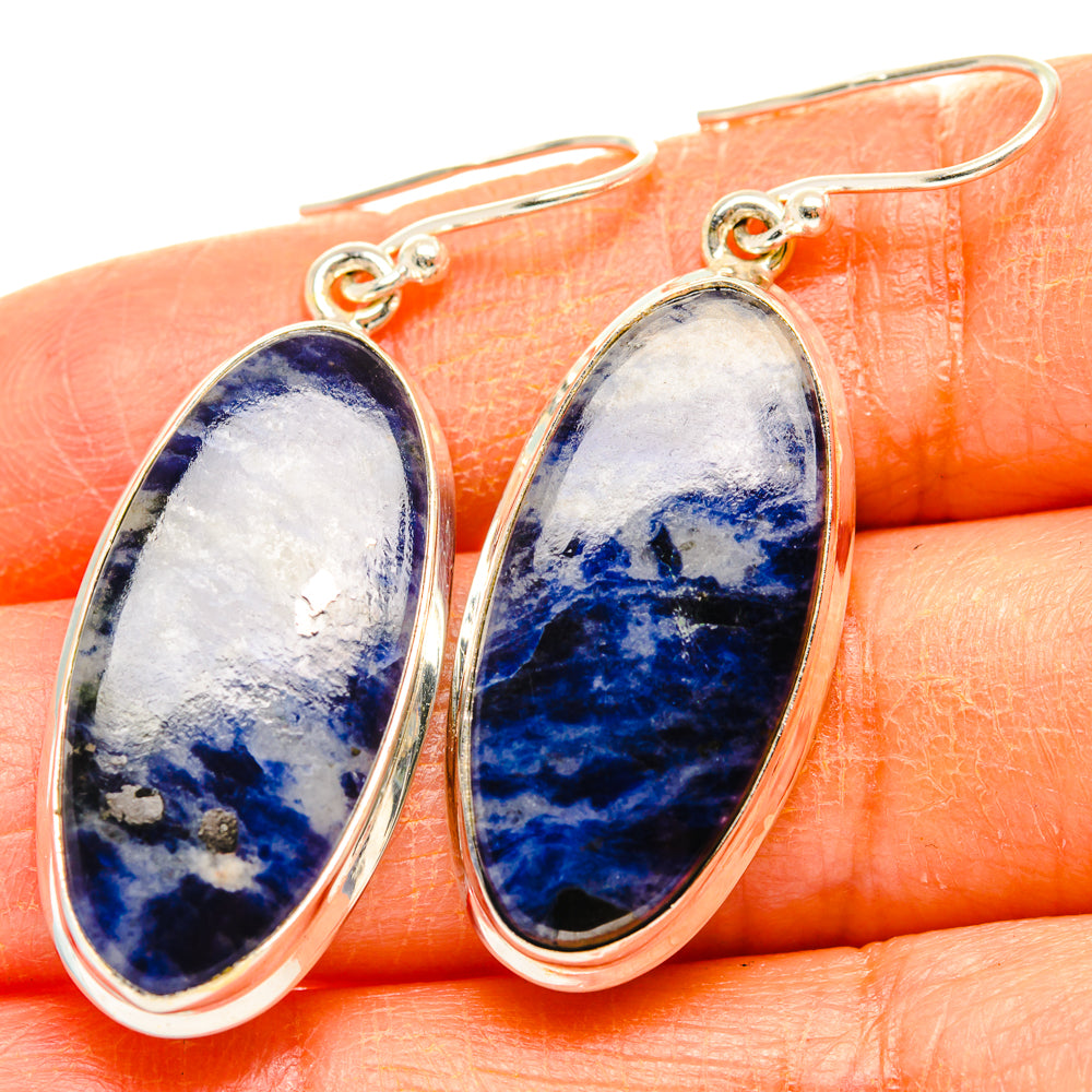 Sodalite stone teardrop earrings in 925 sterling silver, close-up on blue and white
