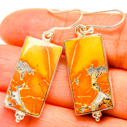 Rectangle jasper drop earrings with orange-yellow stone and sterling silver hooks on hand