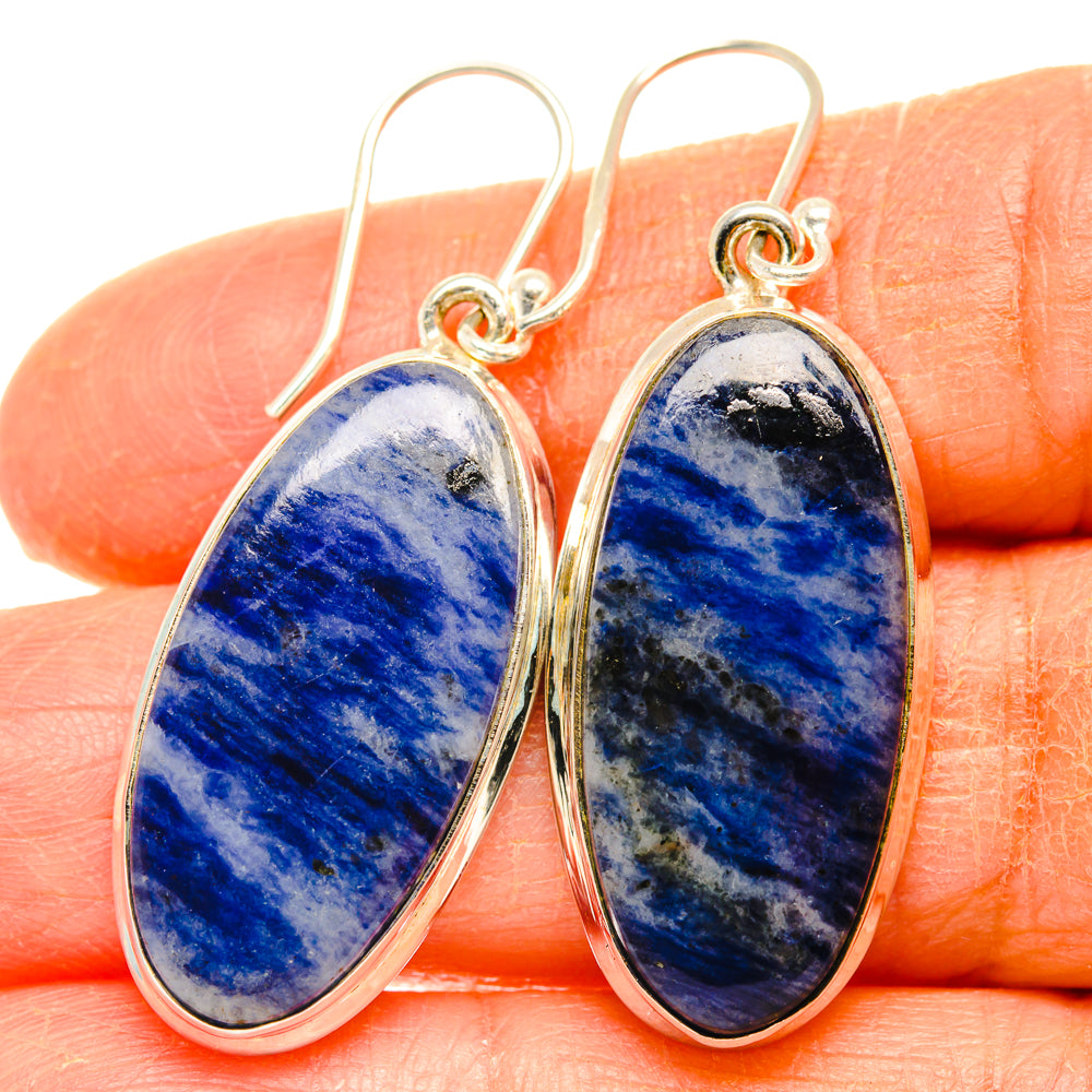 Close-up of oval blue sodalite drop earrings in 925 sterling silver with hook tops