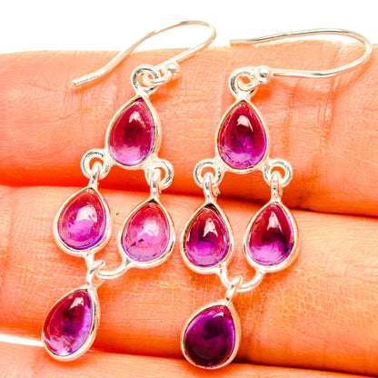 Silver amethyst drop earrings with five purple teardrop stones on dangling clusters