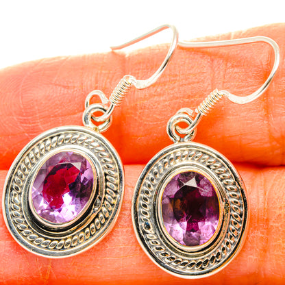 Silver amethyst drop earrings with faceted oval stones in ornate round bezel