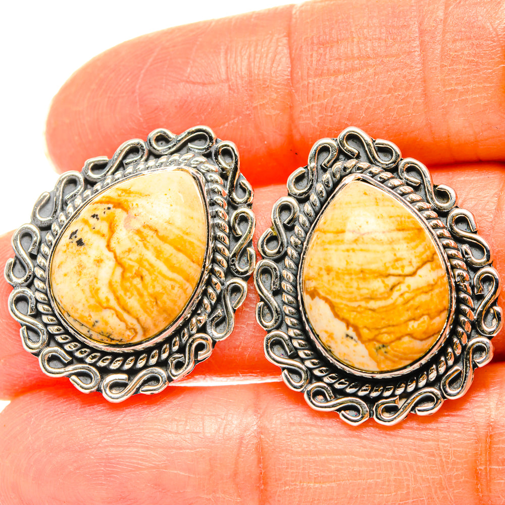 Sterling silver teardrop jasper stud earrings, yellow-orange stone with swirling patterns.