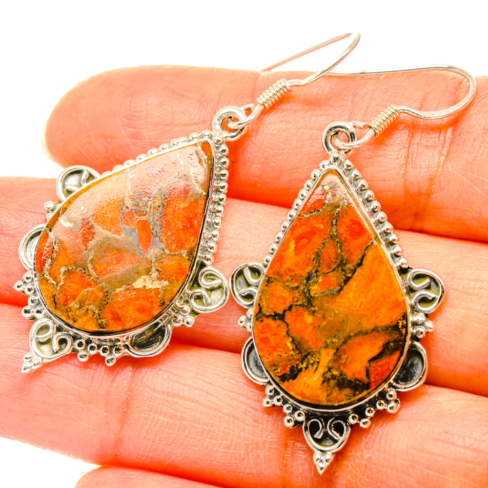 Orange-and-teal teardrop earrings on silver-tone hooks with detailed filigree border